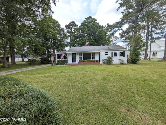 single story home with covered porch and a front lawn