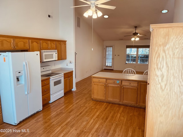 kitchen featuring white appliances, high vaulted ceiling, light wood-type flooring, and ceiling fan