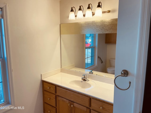 bathroom with vanity and toilet