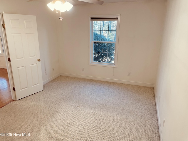 carpeted empty room with ceiling fan