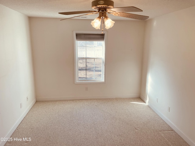 carpeted empty room with a textured ceiling and ceiling fan