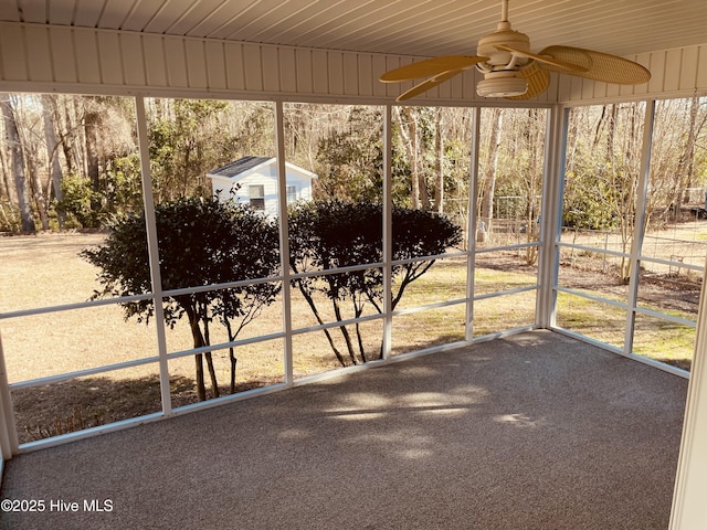 unfurnished sunroom with ceiling fan and plenty of natural light