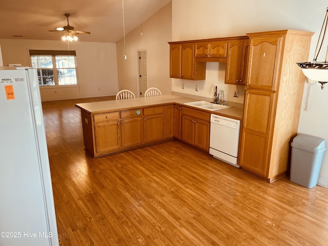 kitchen featuring sink, white appliances, ceiling fan, light wood-type flooring, and kitchen peninsula