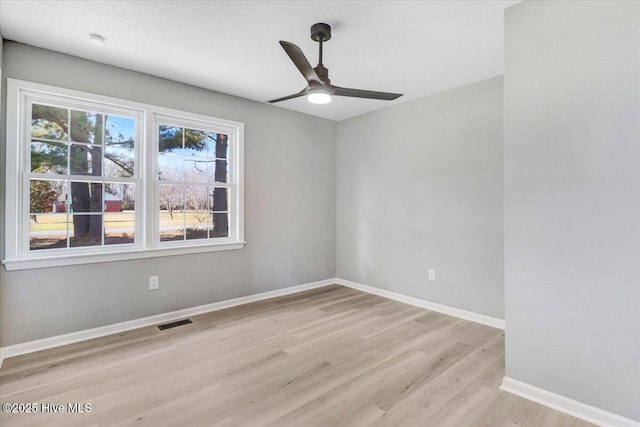 unfurnished room with ceiling fan and light wood-type flooring