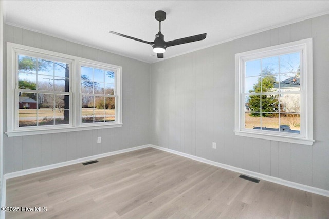 empty room featuring crown molding, ceiling fan, and light hardwood / wood-style floors