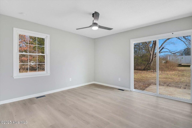 empty room featuring ceiling fan and light hardwood / wood-style flooring