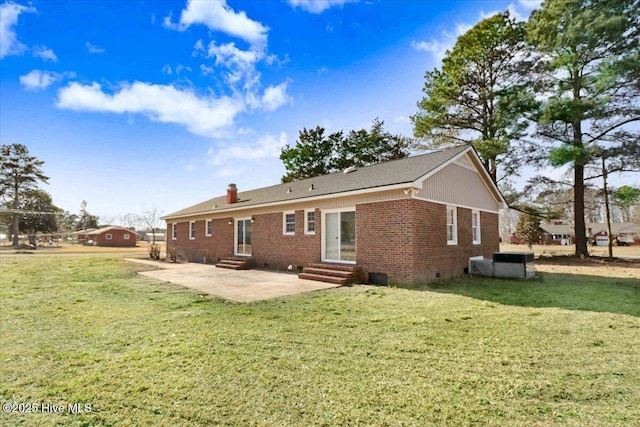 rear view of house with a patio and a lawn