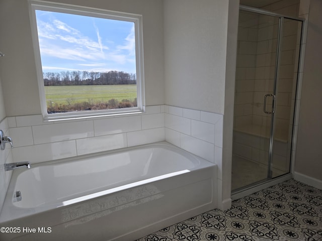 bathroom with separate shower and tub and tile patterned floors