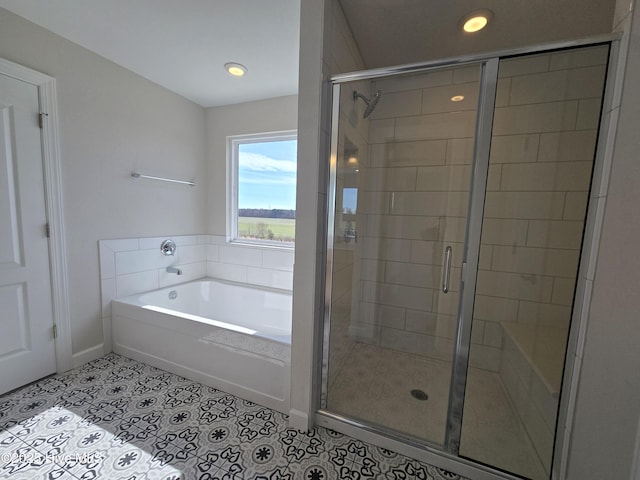 bathroom with separate shower and tub and tile patterned flooring