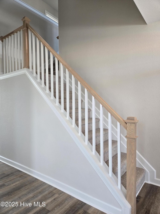 stairs featuring hardwood / wood-style flooring