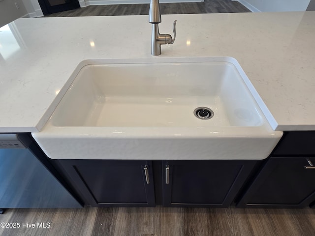 room details with sink, dark hardwood / wood-style flooring, and dishwashing machine