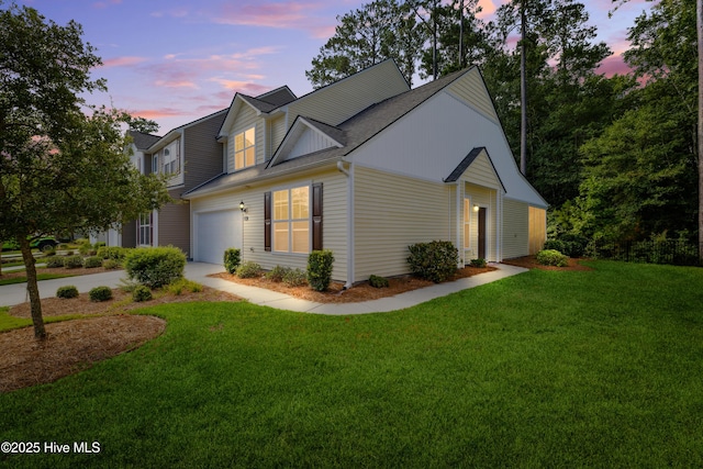 view of front of home featuring a yard and a garage