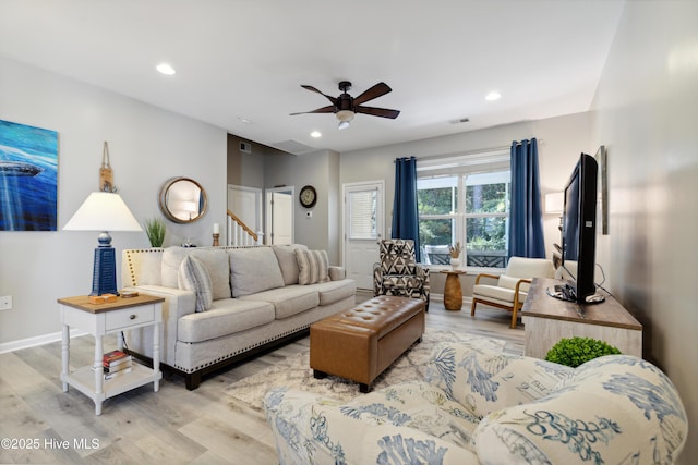 living room with ceiling fan and light wood-type flooring