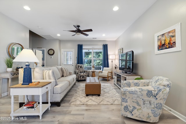 living room with ceiling fan and light hardwood / wood-style floors