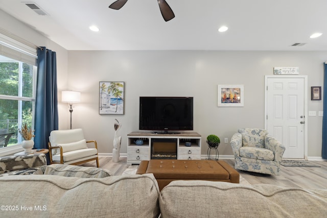 living room with ceiling fan and light hardwood / wood-style floors