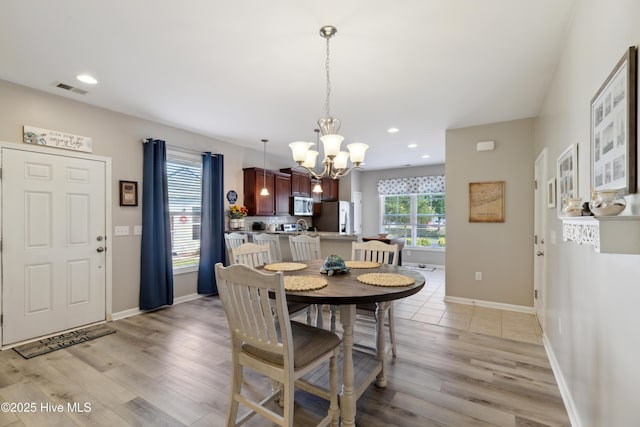 dining room featuring a chandelier and light hardwood / wood-style flooring