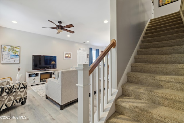 living room with ceiling fan and light hardwood / wood-style floors