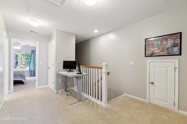 hall with light colored carpet