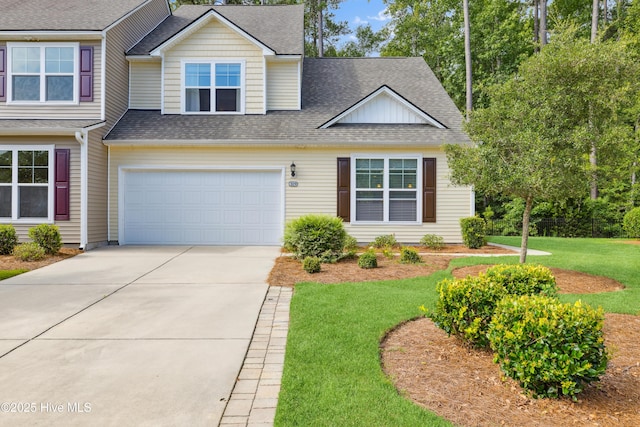 view of front facade featuring a front yard and a garage