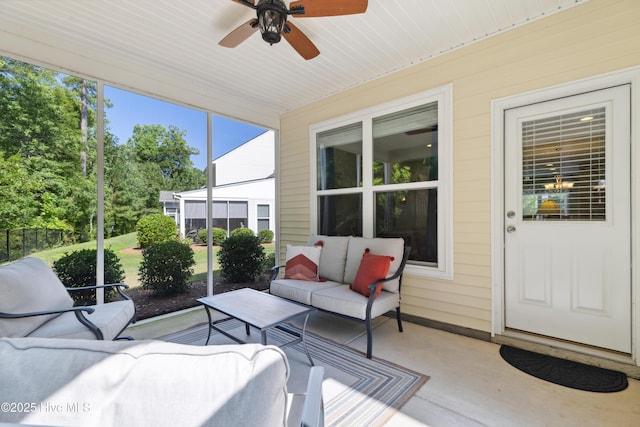 sunroom featuring ceiling fan