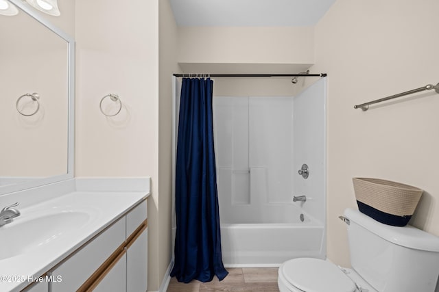 full bathroom with hardwood / wood-style flooring, vanity, toilet, and shower / tub combo