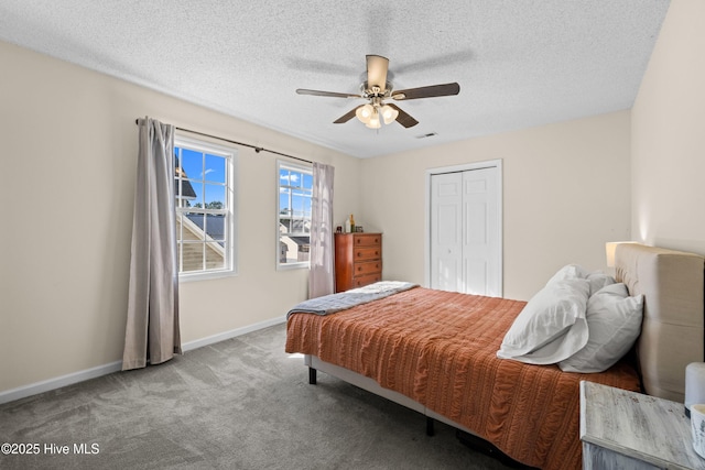 bedroom with ceiling fan, carpet floors, a textured ceiling, and a closet