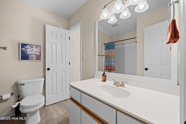 bathroom featuring hardwood / wood-style floors, vanity, toilet, and a shower with curtain