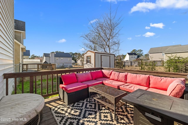 wooden terrace featuring an outdoor living space and a shed