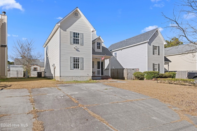 rear view of property featuring a porch