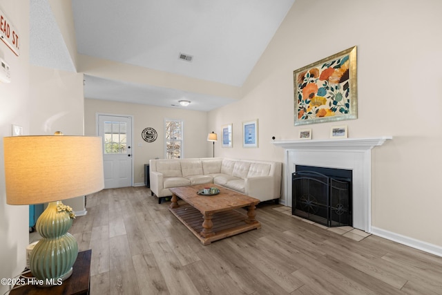 living room featuring hardwood / wood-style floors and lofted ceiling