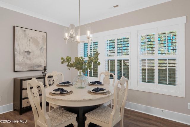 dining room featuring a chandelier, dark hardwood / wood-style floors, and ornamental molding