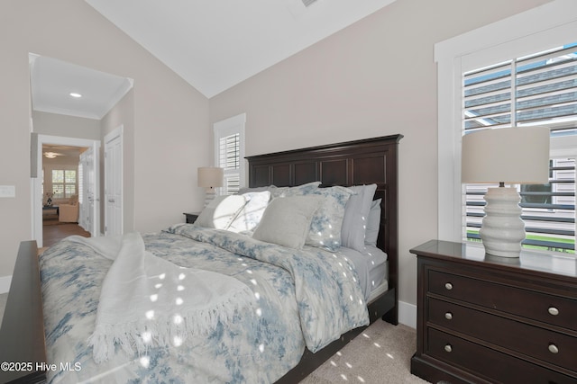 bedroom with lofted ceiling, ornamental molding, and multiple windows