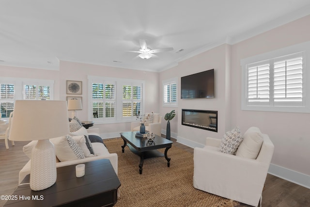 living room with ceiling fan, wood-type flooring, and crown molding