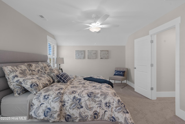 bedroom featuring ceiling fan, light colored carpet, and lofted ceiling