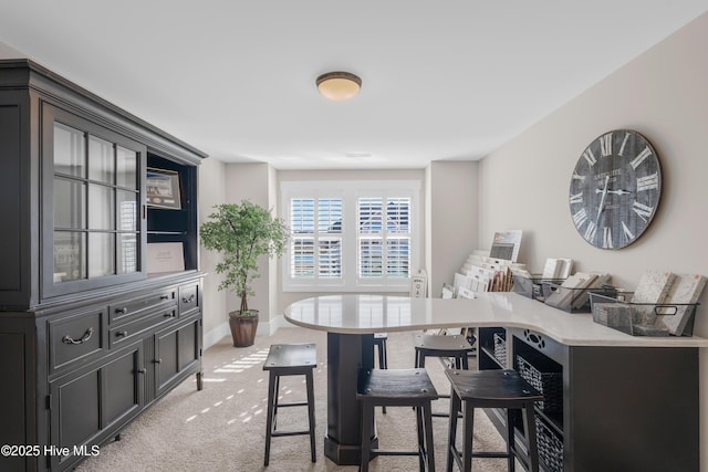 dining area featuring light colored carpet