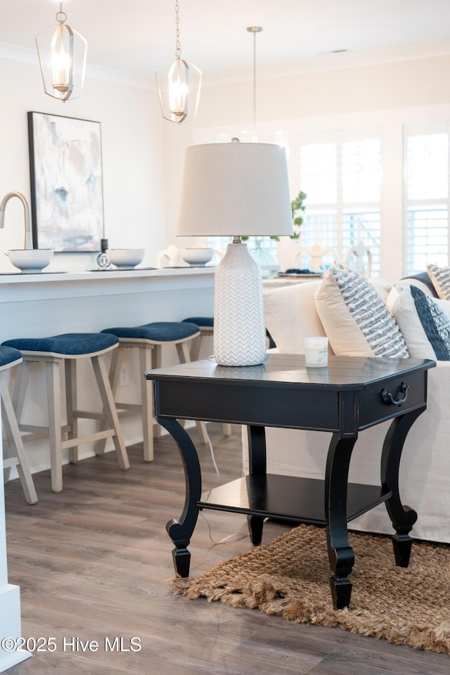 dining space with crown molding and wood-type flooring