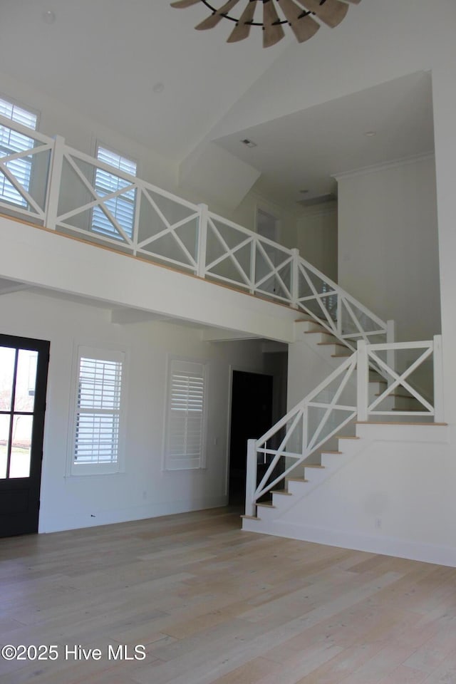 interior space featuring hardwood / wood-style floors and high vaulted ceiling