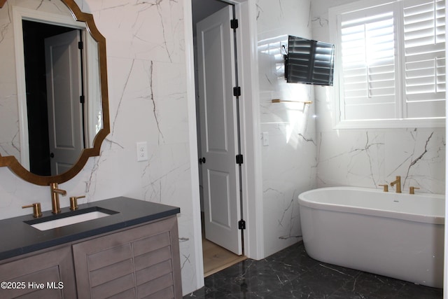 bathroom featuring vanity and a bath