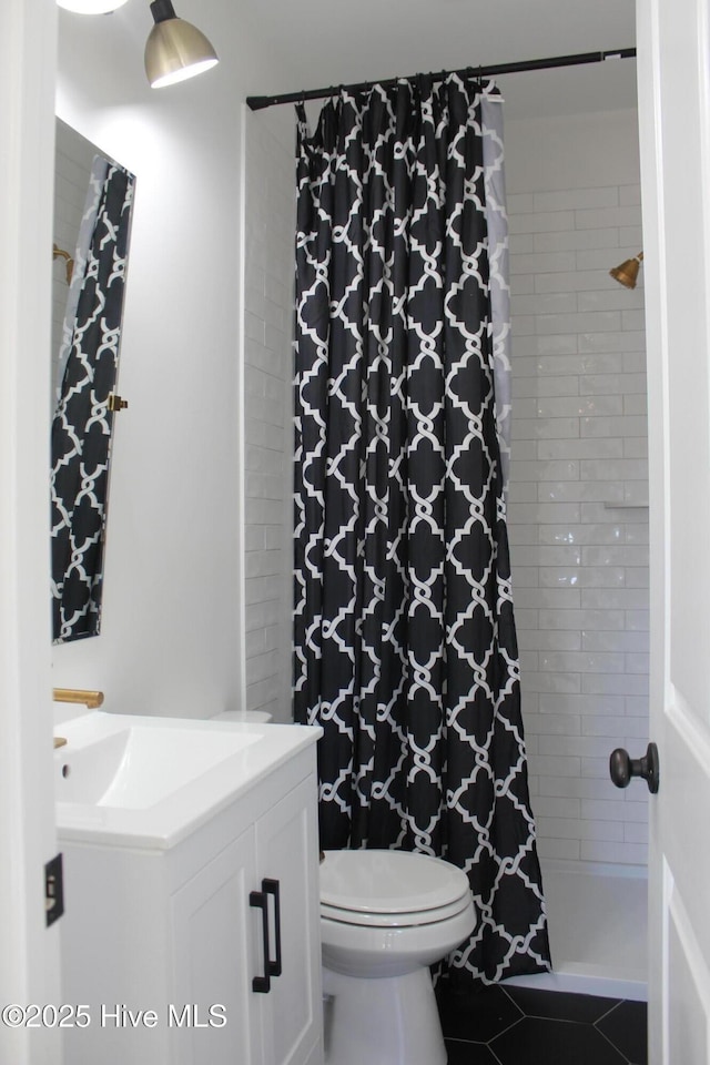 bathroom with tile patterned flooring, vanity, toilet, and a shower with shower curtain