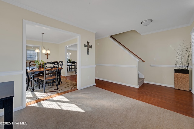 interior space with carpet, a chandelier, and ornamental molding