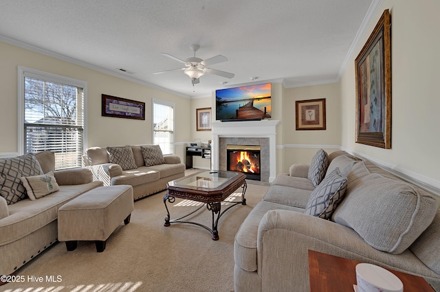 carpeted living room with a textured ceiling, ceiling fan, and crown molding