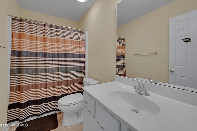 bathroom with vanity, a textured ceiling, tile patterned floors, and toilet