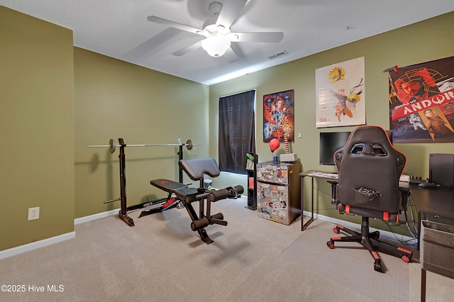 workout area with light colored carpet and ceiling fan