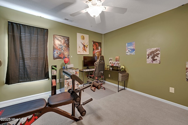 workout room with light colored carpet and ceiling fan