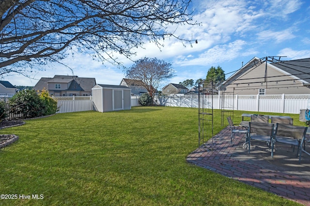 view of yard featuring a water view, a storage unit, and a patio area