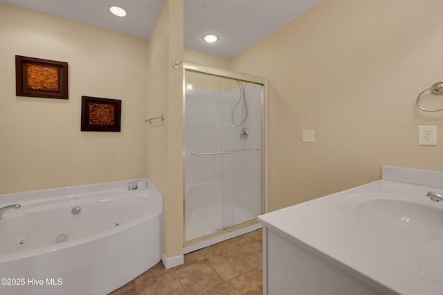 bathroom with tile patterned flooring, vanity, and independent shower and bath