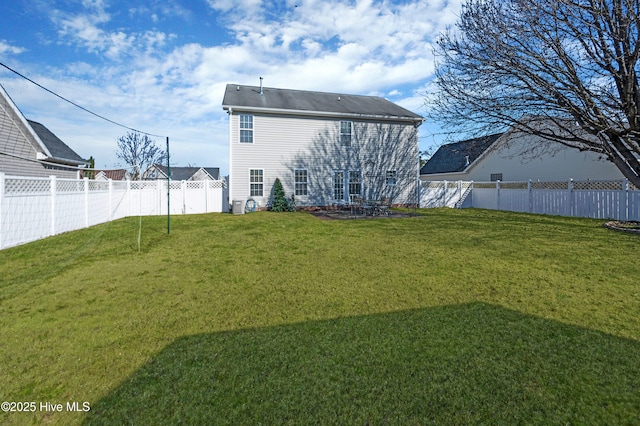 rear view of property with a lawn