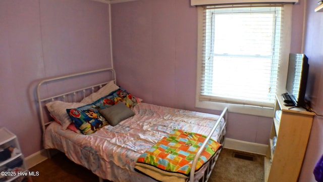 carpeted bedroom with multiple windows