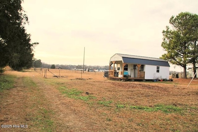 view of yard featuring a rural view and a porch