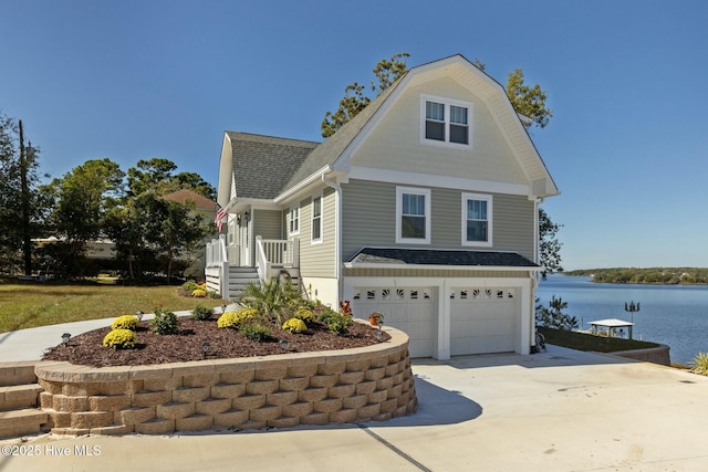 view of side of home with a garage and a water view